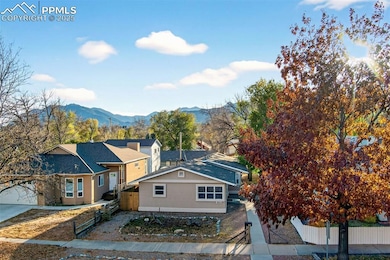 View of front of house featuring stucco siding and a mountain view