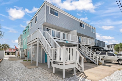 Rear view of property featuring stairs and a deck