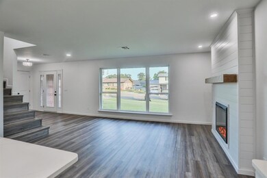 Unfurnished living room featuring a large fireplac
