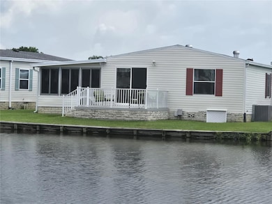 Rear of home, with patio over looking pond