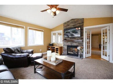 Window-wrapped family room with vaulted ceiling an