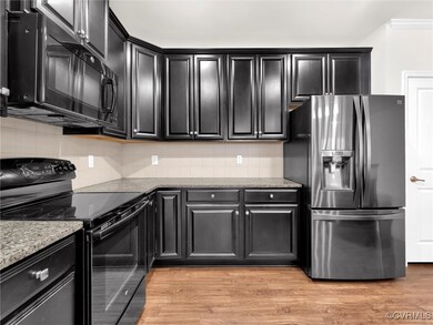 Kitchen with tasteful backsplash, light stone coun