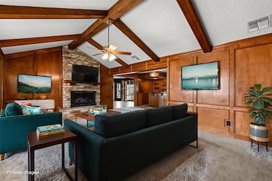 Living room with a ceiling fan, visible vents, lo