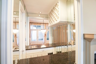 The mirrored double-sided wet bar is a striking fe