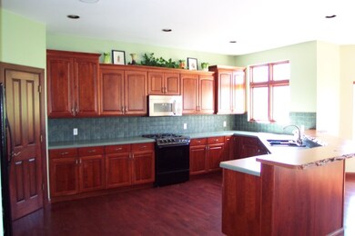 Kitchen with Amish made Cherry Cabinets.  Live Edg