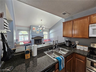 Kitchen featuring brown cabinets, a sink, white mi