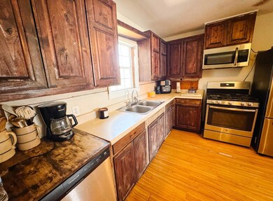 Kitchen featuring light wood-style flooring, stain