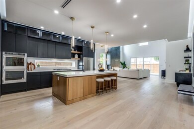 Kitchen with stainless steel appliances, light woo