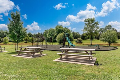 View of home's community with a playground and a y
