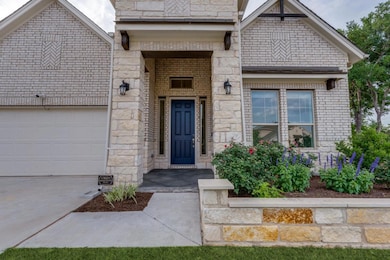 Property entrance featuring concrete driveway, a 