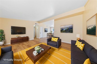 Living room with wood finished floors and baseboar