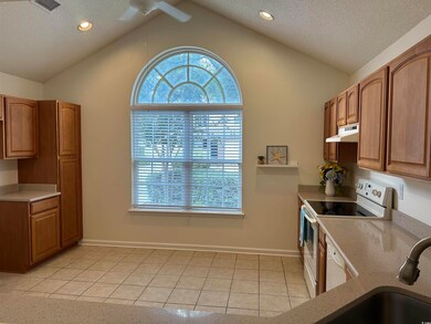 Kitchen featuring electric stove, ceiling fan, lof