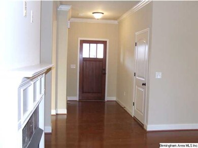 Wide, wooded foyer open to the large family room a
