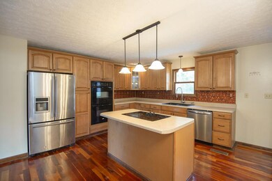 Gorgeous Kitchen! Cherry Hardwood Floors, Stainless/Black Appliances, Double Oven, Island with Cooktop