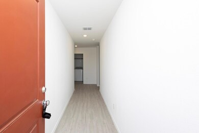Hall with light hardwood / wood-style floors