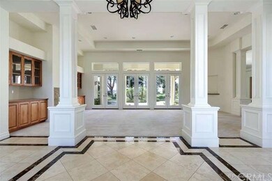 Grand entry with travertine and marble floors and 