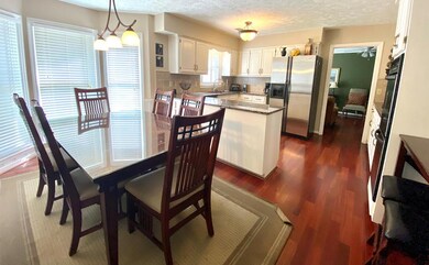 Eat-in kitchen with granite counters and white cab