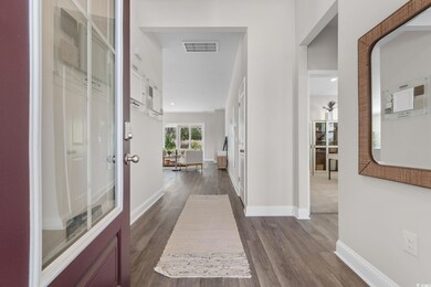 Corridor featuring dark wood-type flooring and baseboards