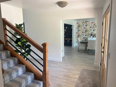 Stairs with wood finished floors and baseboards