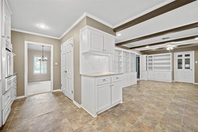Kitchen featuring ceiling fan with notable chandel