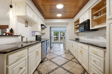 Modern kitchen. Equipped with granite countertops, stainless steel appliances, and ample cabinetry.
