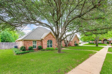 View of front of house with central AC unit and a front yard