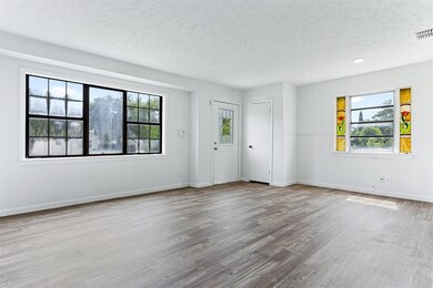 Spare room with a textured ceiling and light wood-