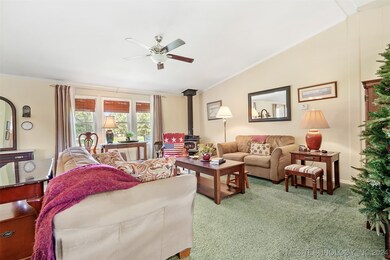 The vauilted ceiling of the home overlooks the living room.  Note the wood stove in the corner which easily heats the home during cold snaps!