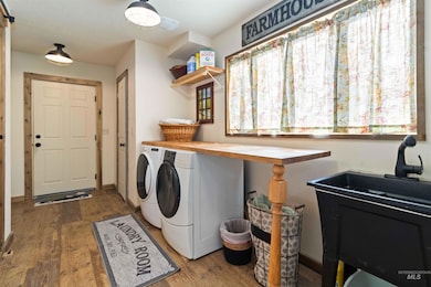 Laundry room with washer and dryer and wood finished floors