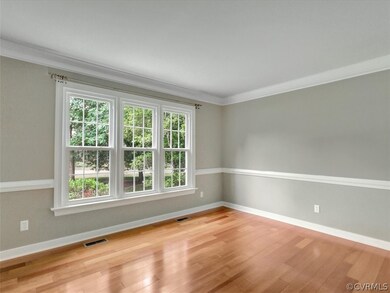 Living Room ~with triple windows overlooking the m