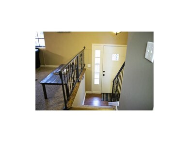 A warm and contemporary entry with wood and iron a