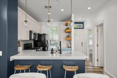 Kitchen featuring black appliances, a peninsula, 