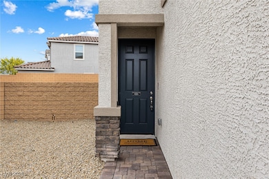 Entrance to property with stucco siding, fence, an
