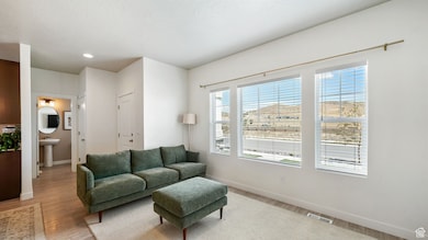 Living room featuring light wood finished floors and recessed lighting