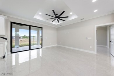 Spare room with crown molding, a ceiling fan, visi