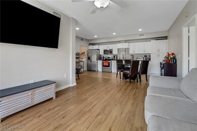 Living area featuring a ceiling fan, light wood-st