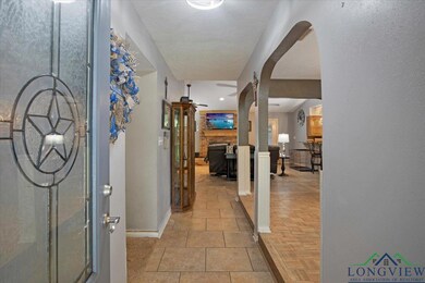 Corridor featuring baseboards and arched walkways