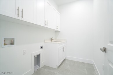 Washroom with electric dryer hookup, cabinet space