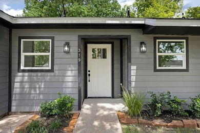 Front entry with lush landscape throughout