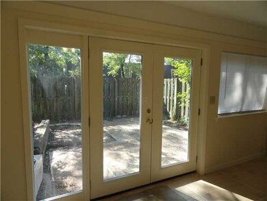 French doors lead to private fenced patio area and