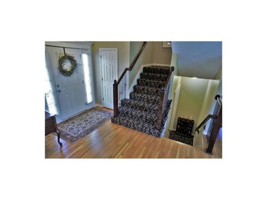 Open floorplan with hardwoods, custom stair carpet