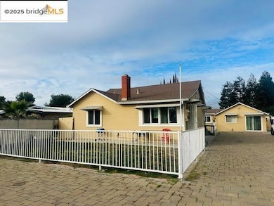 View of front of property featuring a fenced front yard and a chimney