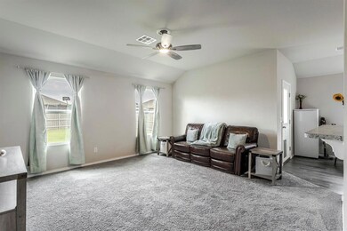 Living room with vaulted ceiling and ceiling fan