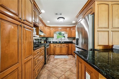 Beautifully updated kitchen with warm wood cabinet