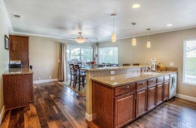 Open family kitchen with hardwood floors throughou