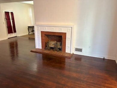 Unfurnished living room with dark wood-type floori