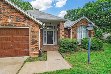 Property entrance featuring a garage and a lawn