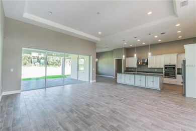 Great Room with trey ceiling, quadruple sliding do