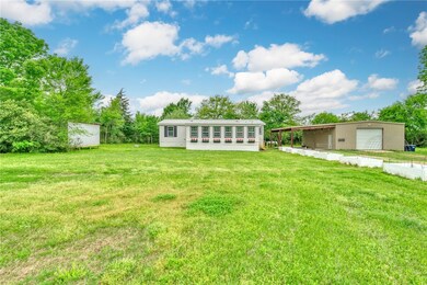 View of front of property with a front lawn, a gar