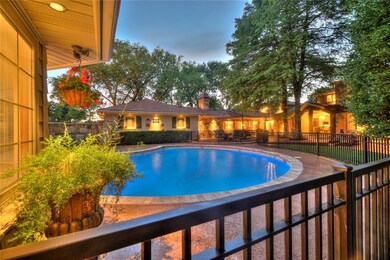 Stunning pool that has iron gates around it lots of entertaining space for dining and relaxing.